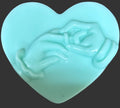 Heart-shaped green soap with a design 